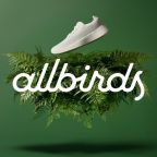 All birds logo on greenery, against a green background with a floating white allbirds tennis shoe