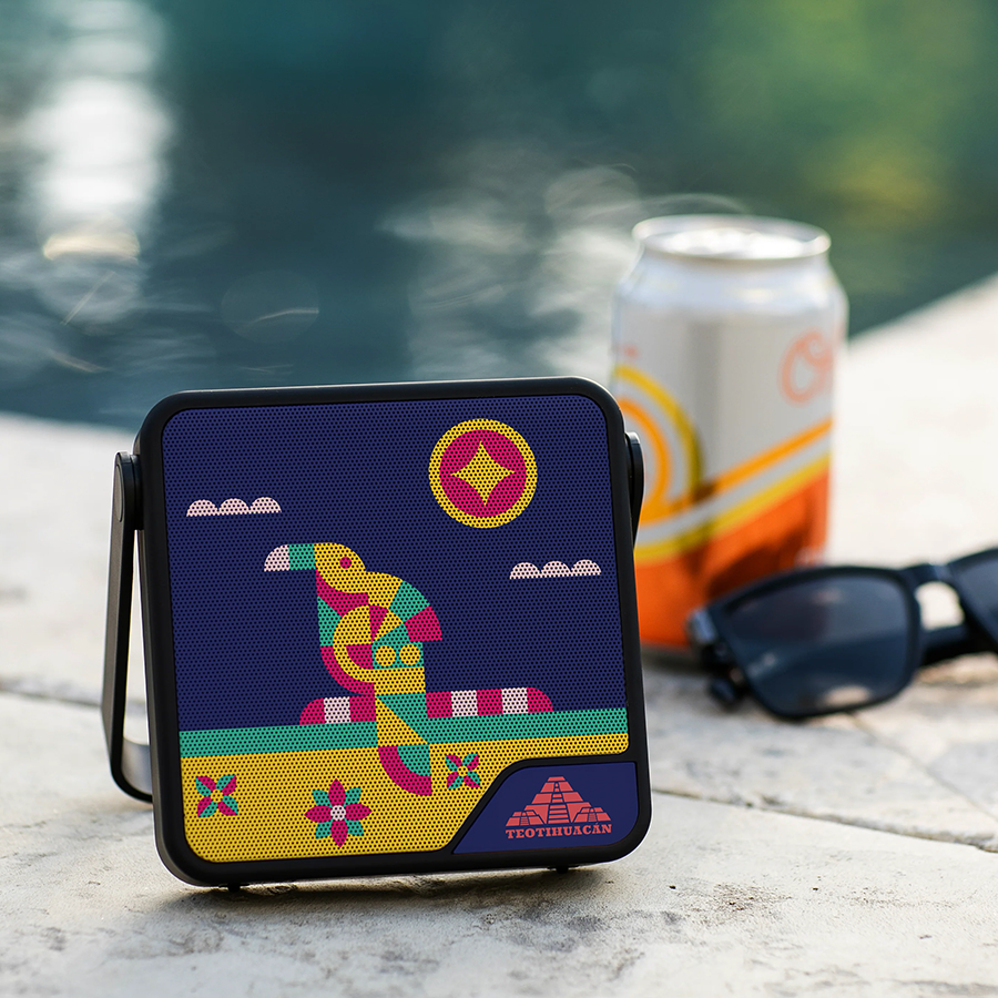 Rupt-Speaker-Pool Creatively skinned Waterproof RUPT Bluetooth speaker by the pool, next to a soda can and sunglasses